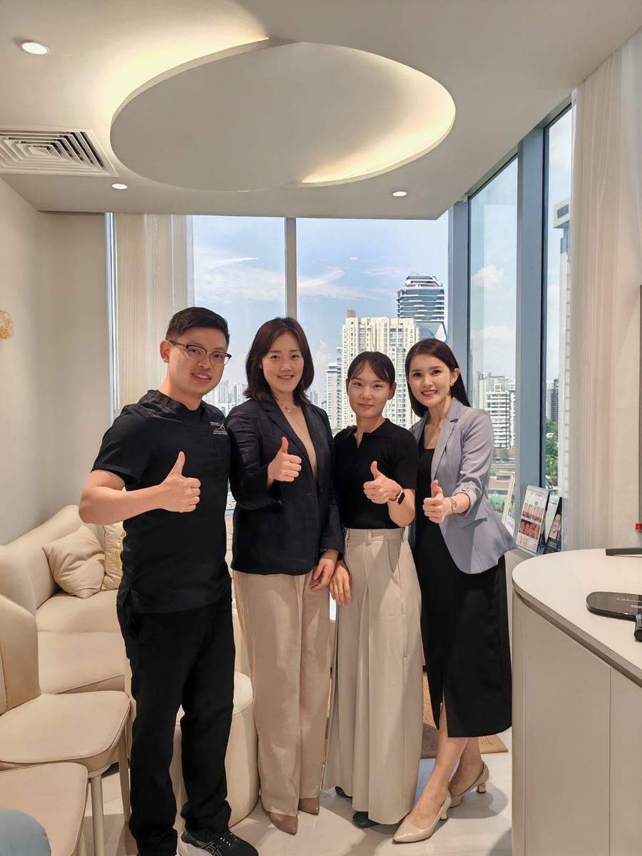 Dr Sin Yong with HIRONIC Korean headquarters team at IN Eternity Clinic on 9 Scotts Road, #12-01 Pacific Plaza, Singapore, October 2025 — city skyline visible